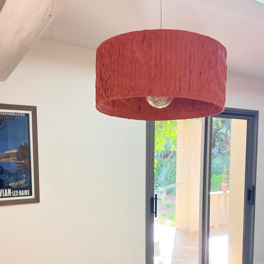 Suspension Cylindre Orange Terracotta dans un intérieur lumineux, luminaire design fabriqué à la main en Provence
